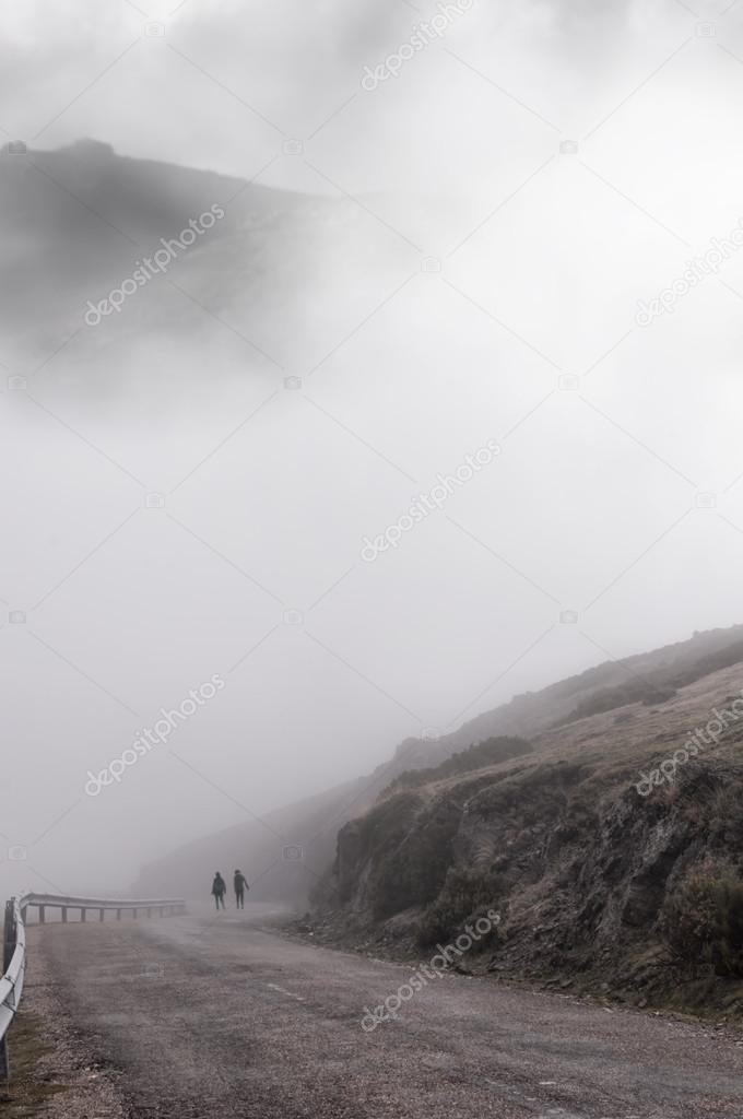 Women walking through the thick fog