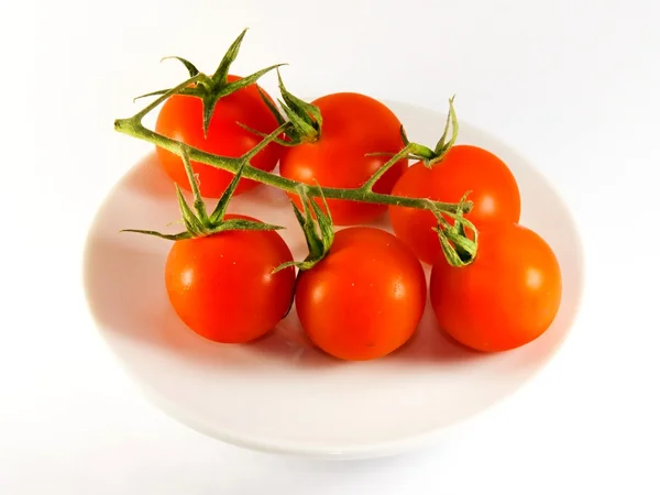 Red tomatoes on a plate — Stock Photo, Image