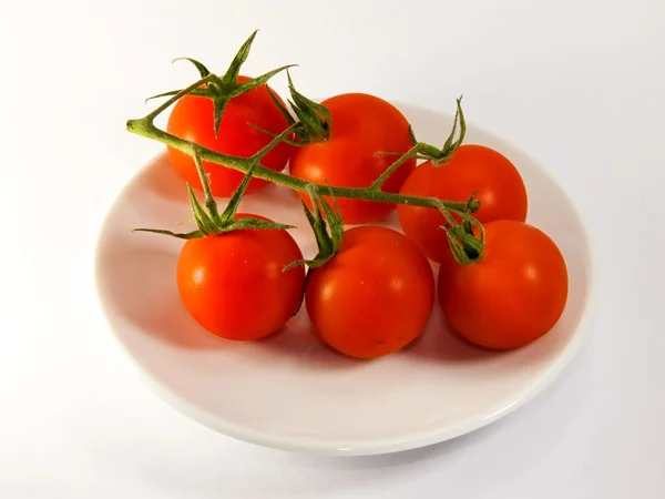 Red tomatoes on a plate — Stock Photo, Image