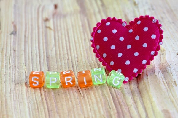 Spring sign with heart on the wood — Stock Photo, Image