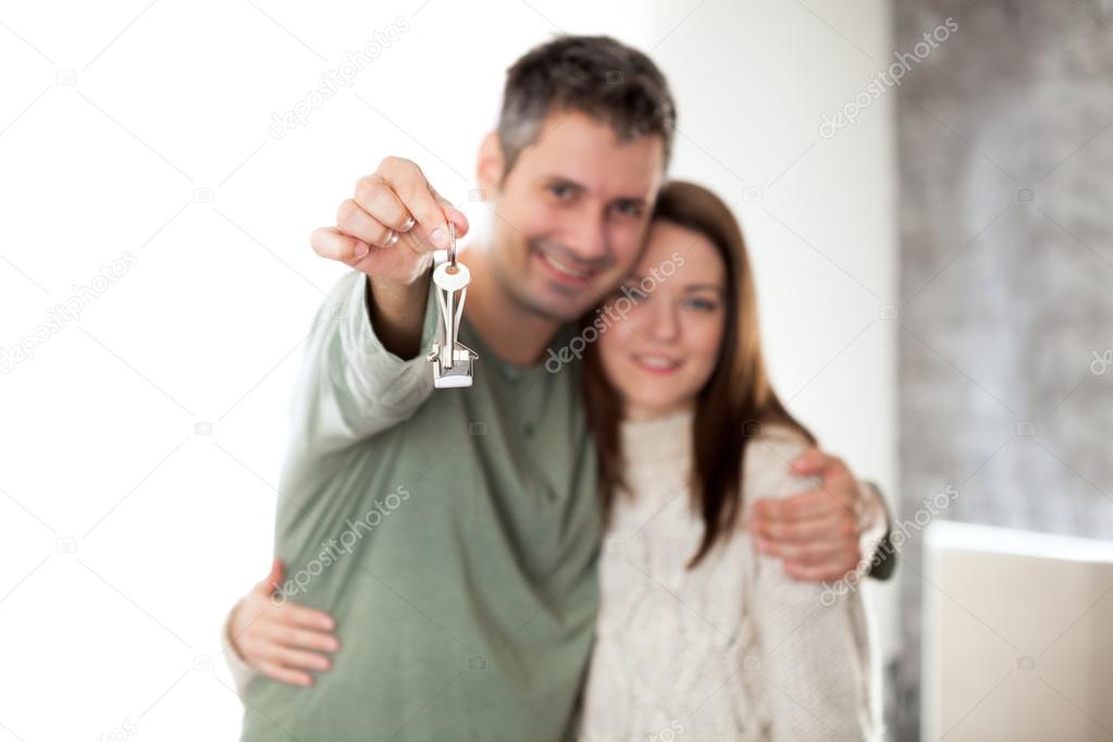 Happy young couple moving into a new home