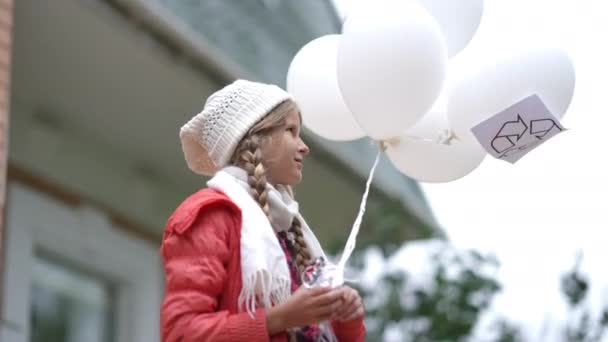 Side view portræt smilende charmerende teenage pige stående udendørs holder hvide balloner med genbrug symbol ser væk. Selvsikker bekymret kaukasisk teenager øko-aktivist. – Stock-video