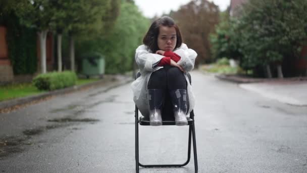Depressed Frustrated Little Woman Rain Coat Sitting Chair Outdoors Hugging — Stock Video
