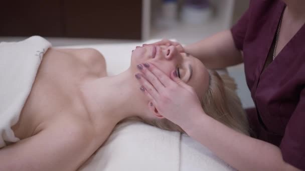 Hands Professional Masseur Massaging Cheeks Beautiful Woman Closed Eyes Side — Stock Video
