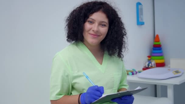 Charming Size Woman Medical Uniform Smiling Looking Camera Filling Case — Vídeo de Stock