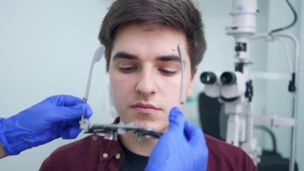 Satisfied Young Man Smiling Looking Camera Doctor Putting Trial Frame — Stock video