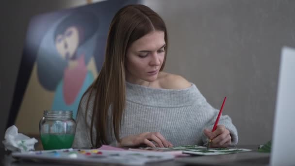Focused Positive Woman Redrawing Picture Laptop Sitting Indoors Portrait Confident — Stockvideo