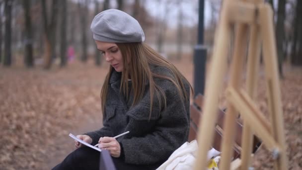 Charming Talented Young Woman Sitting Bench Drawing Sketch Looking Camera — ストック動画