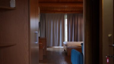 Live camera entering hotel room with no people in slow motion. Wide shot comfortable tourist resort with nobody indoors. Travelling and tourism concept