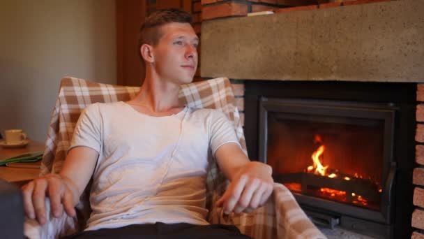 Young Thoughtful Happy Man Admiring Flame Burning Fireplace Slow Motion — Stok video