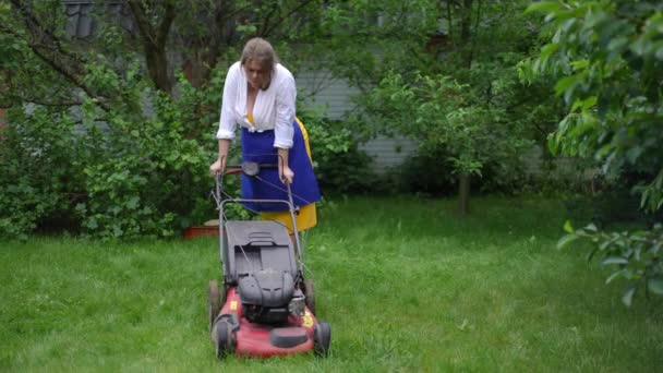 Wide Shot Tired Woman Standing Lawn Mower Summer Garden Looking — Video