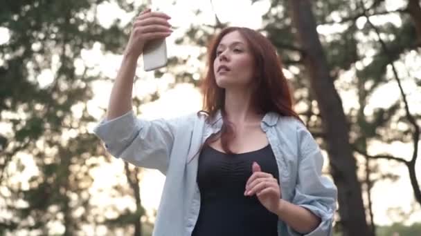 Charming Slim Woman Raising Phone Searching Internet Rejoicing Sunshine Forest — Stok video