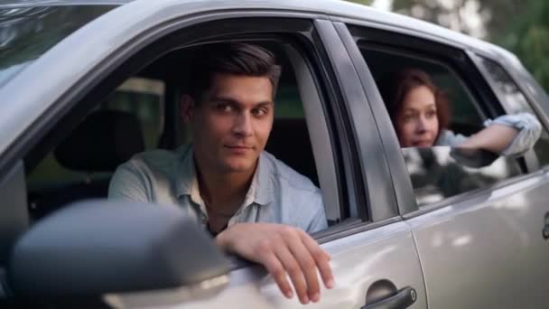 Smiling Handsome Man Sitting Drivers Seat Talking Blurred Beautiful Woman — Vídeo de stock