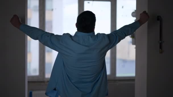 Back View Silhouette Young Man Stretching Looking Out Window New — Vídeo de Stock