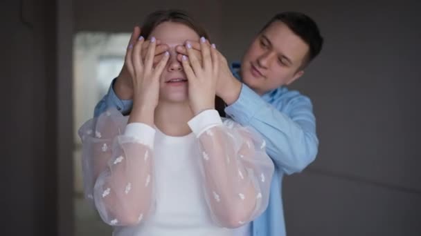 Portrait Excited Young Woman New Flat Man Covering Eyes Hands — Stockvideo