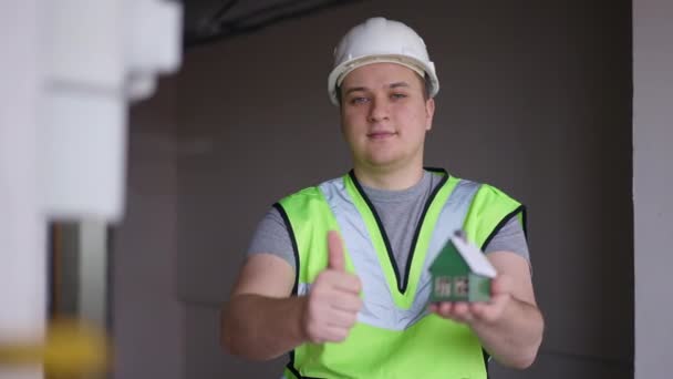 Medium Shot Front View Confident Builder Gesturing Thumb Showing Toy — Vídeo de Stock