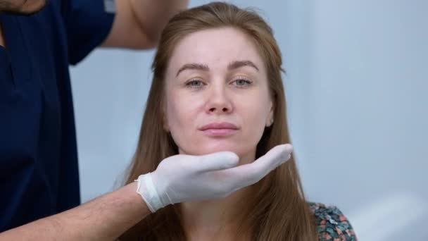 Portrait Concentrated Woman Posing Plastic Surgery Clinic Unrecognizable Man Touching — Video
