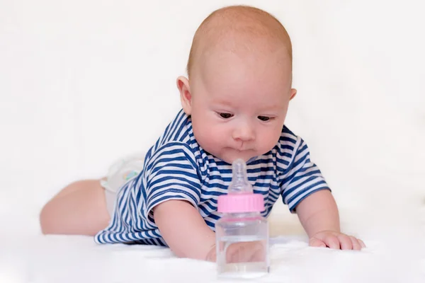 Newborn baby with a bottle — Stockfoto