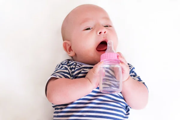 Newborn baby with a bottle — ストック写真