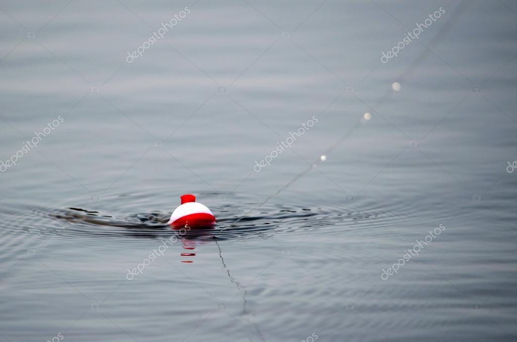 Fishing bobber in the water — Stock Photo © inyrdreams 30765605