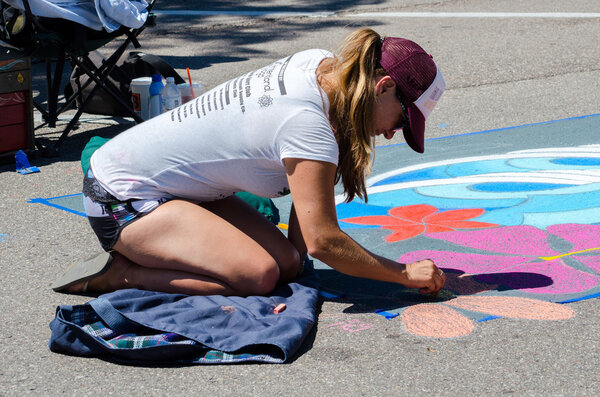 Creating  chalk art on the street