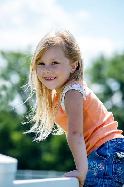 Adorable blond child on fence — Stock Photo, Image