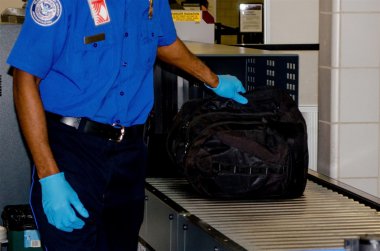 TSA handling a bag clipart