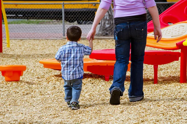 Very young child being walked to a bus — Stock Photo, Image