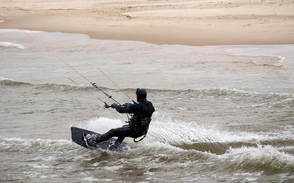 Kiteboarder breaking water — Stock Photo, Image