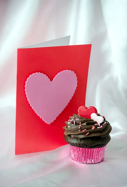 Valentine with chocolate frosted cupcake — Stock Photo, Image