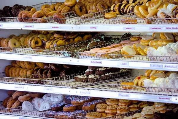 Racks Delicious Doughnuts Displayed Sale Local Pastry Shop — Stock Photo, Image