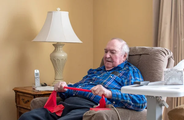 Senior Male Uses Resistance Exercise Band Exercise Home His Lift — Foto de Stock