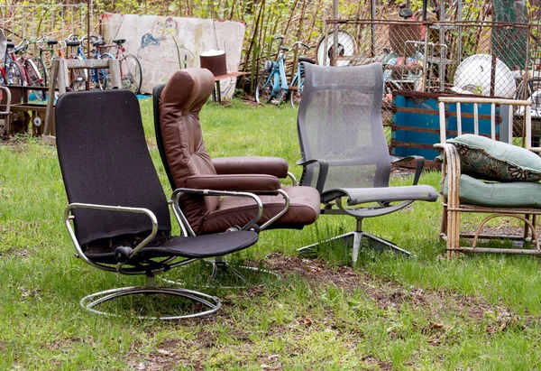 a variety of chairs are for sale at an outdoor yard sale in Michigan USA