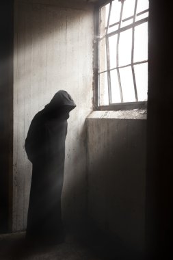 Reaper waiting in a dark abandoned building clipart
