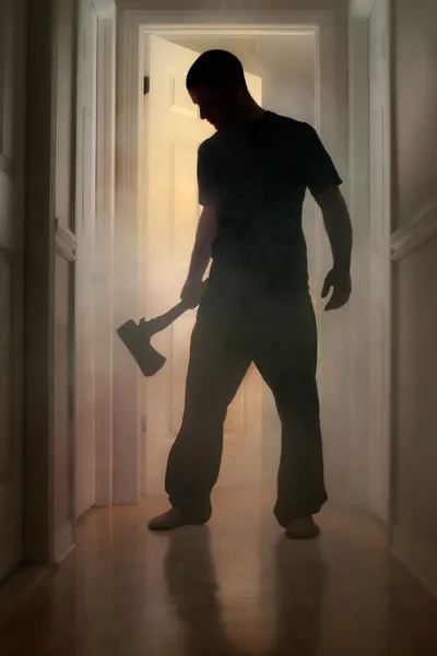 Epic concept with man holding axe inside a smoking house — Stock Photo, Image