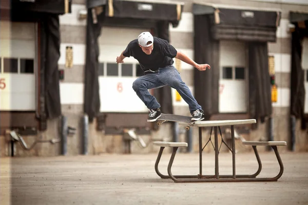 Skateboarder doing a Crooked Grind on a Picnic table — Stock Photo, Image