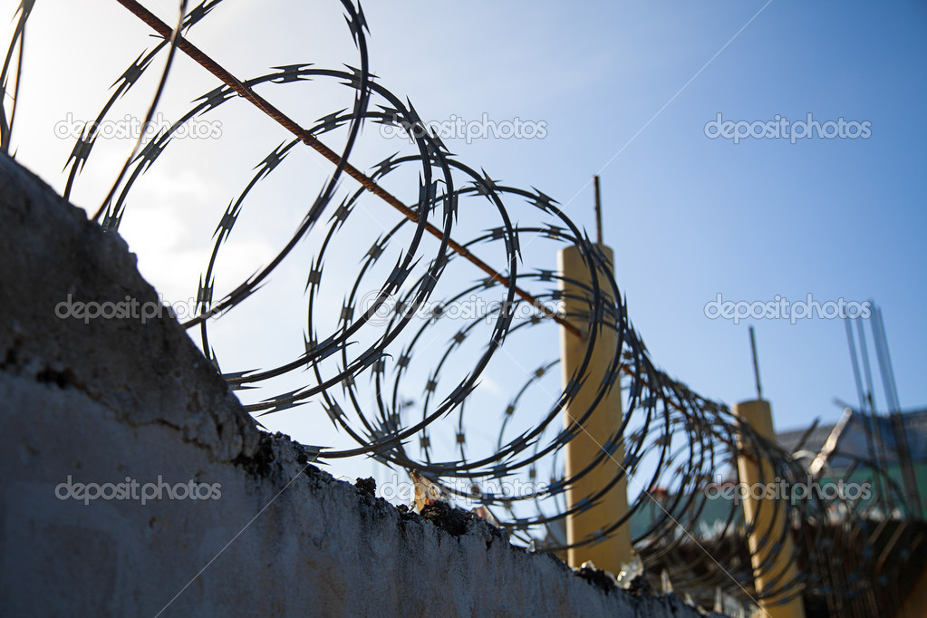 Barbed Wire on top of a old Wall