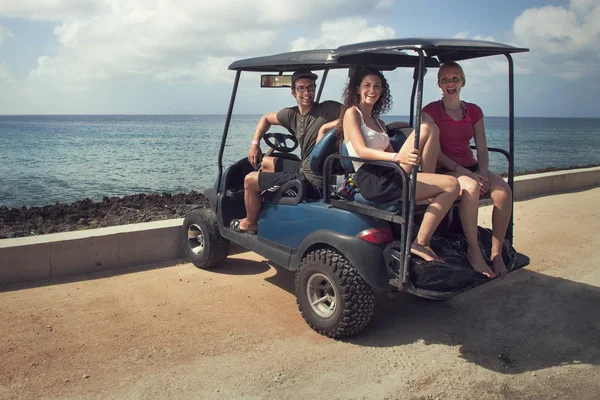 Turistas de árvores que viajam com um carrinho de golfe — Fotografia de Stock