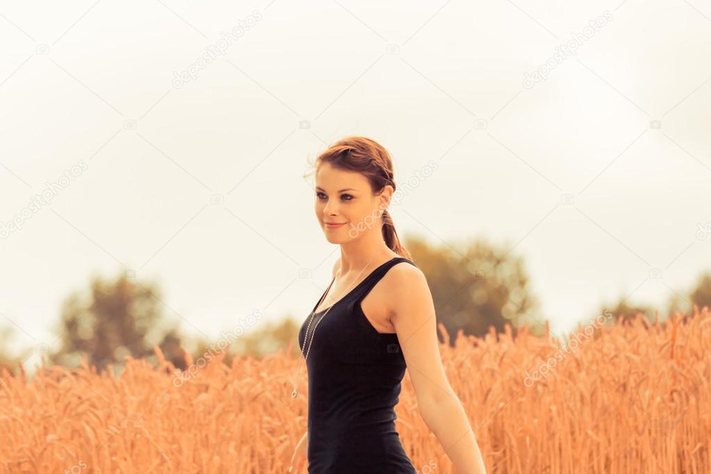 Beautiful young woman in nature feeling happy and free