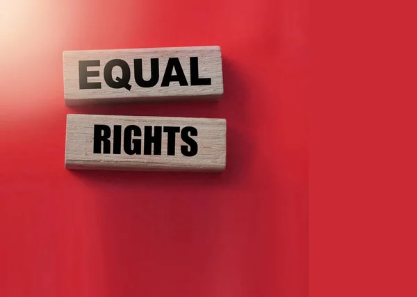 Equal Rights, words on wooden blocks on red background. Equality social concept