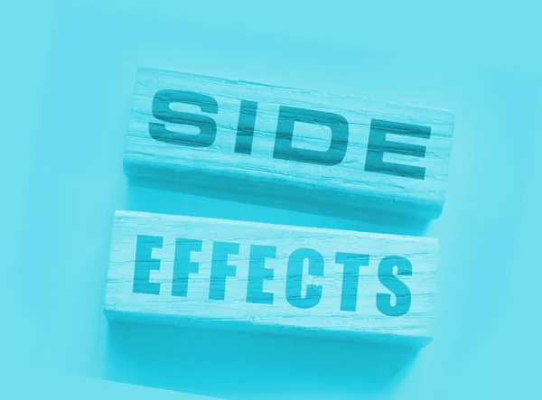 SIDE EFFECTs on wooden blocks. Pharmaceutical medical drugs Concept.