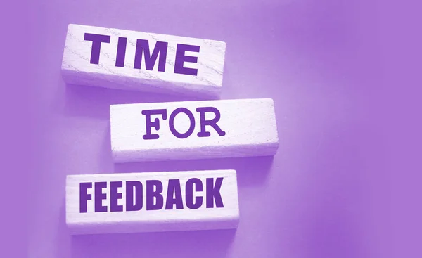 Time fir feedback text on wooden blocks. Product or service evaluation and clients feedback in business concept.