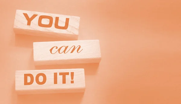 YOU CAN DO IT word on wooden blocks on neutral background. Business concept.. Motivation affirmation encouraging words for personal achievements concept.