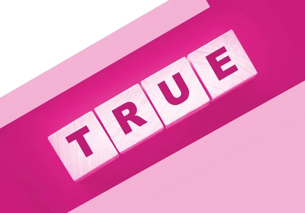 Concept Word True Wooden Cubes Pink Background — Stok fotoğraf