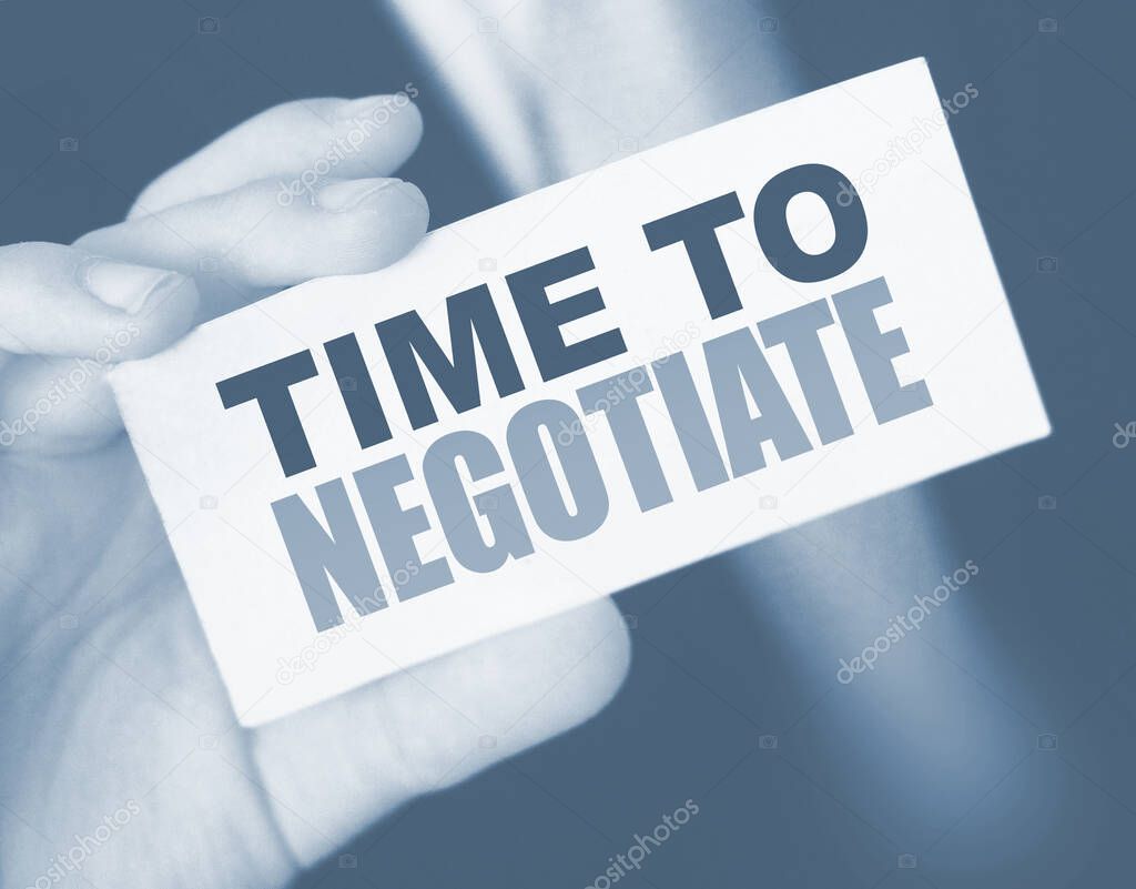 Time to negotiate words on a card in businessmans pocket. Compromise in business concept