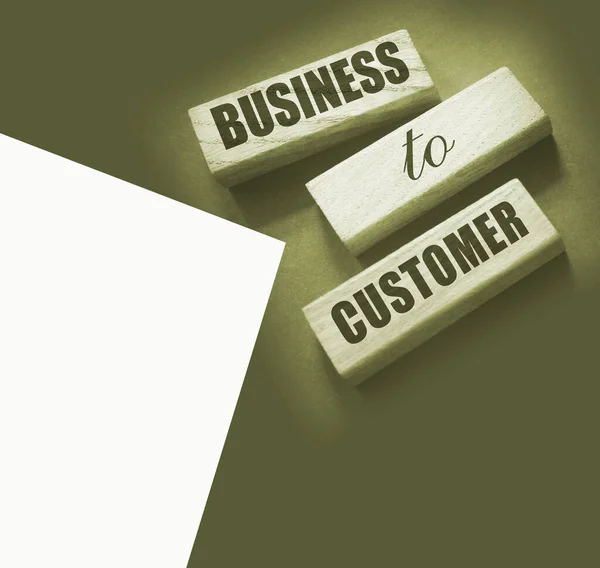 Business to Customer inscription made on wooden blocks on grey tabletop. B2C business marketing concept.