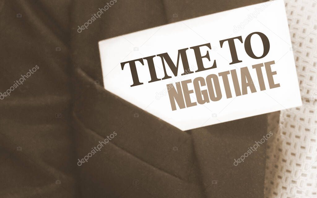 Time to negotiate words on a card in businessman's pocket. Compromise in business concept.