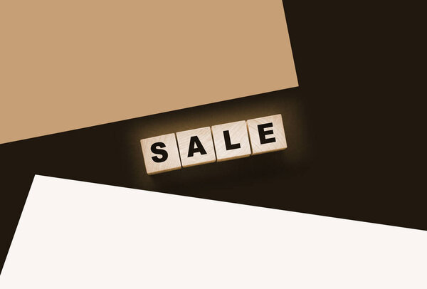 The word sale on wooden cubes on a black background. Business concept