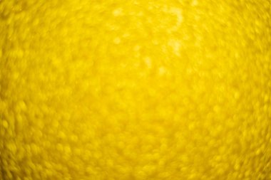 Altın rengi pulların bulanık, pırıl pırıl arka planı. Gümüş parıltı, soyut bokeh dokusu. Çizim tasarımı. Noel için parlak duvar kağıtları. Parti zamanı.