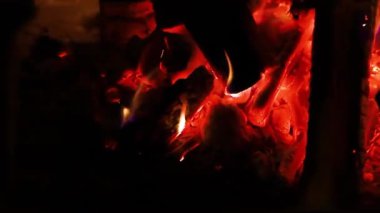 Bonfire close-up, burning tree. The orange flame of the campfire. Preparation of coals for barbecue or frying meat.Natural background and texture.